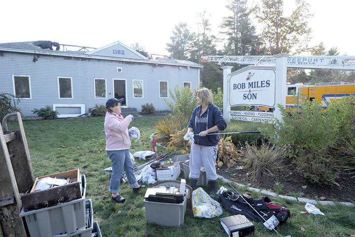 Jane Miles and Samantha Maheux are among family and friends who are helping with the cleanup after a fire gutted the Bob Miles & Son contracting business on Route 1 in Freeport.