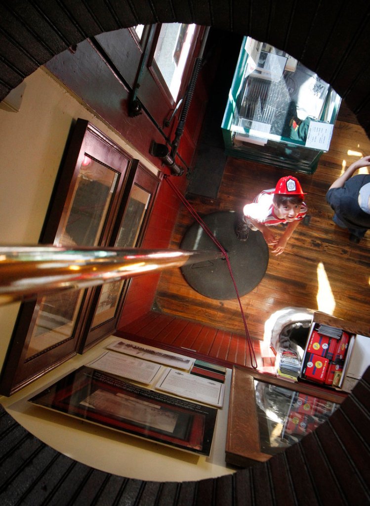 Mathias Jacobs, 7, of Falmouth, Mass., looks up at a firehouse pole during the Portland Fire Museum's ninth annual open house.