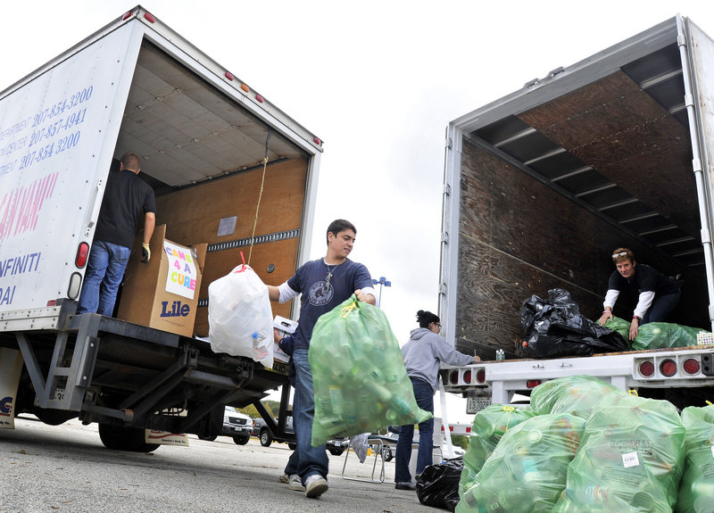 Victor Rios, founder of Exposed Clothes, a company started in memory of his grandmother, who had cancer, unloads cans at the Maine Mall on Wednesday as part of WJBQ’s fundraiser.