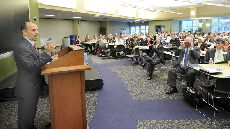 Jamie Merisotis, CEO of Lumina Foundation, speaks at the symposium on higher education at Unum in Portland. “Maine will put itself at some peril if it doesn’t (realize) the need” to focus more on teaching job-critical skills, he said.