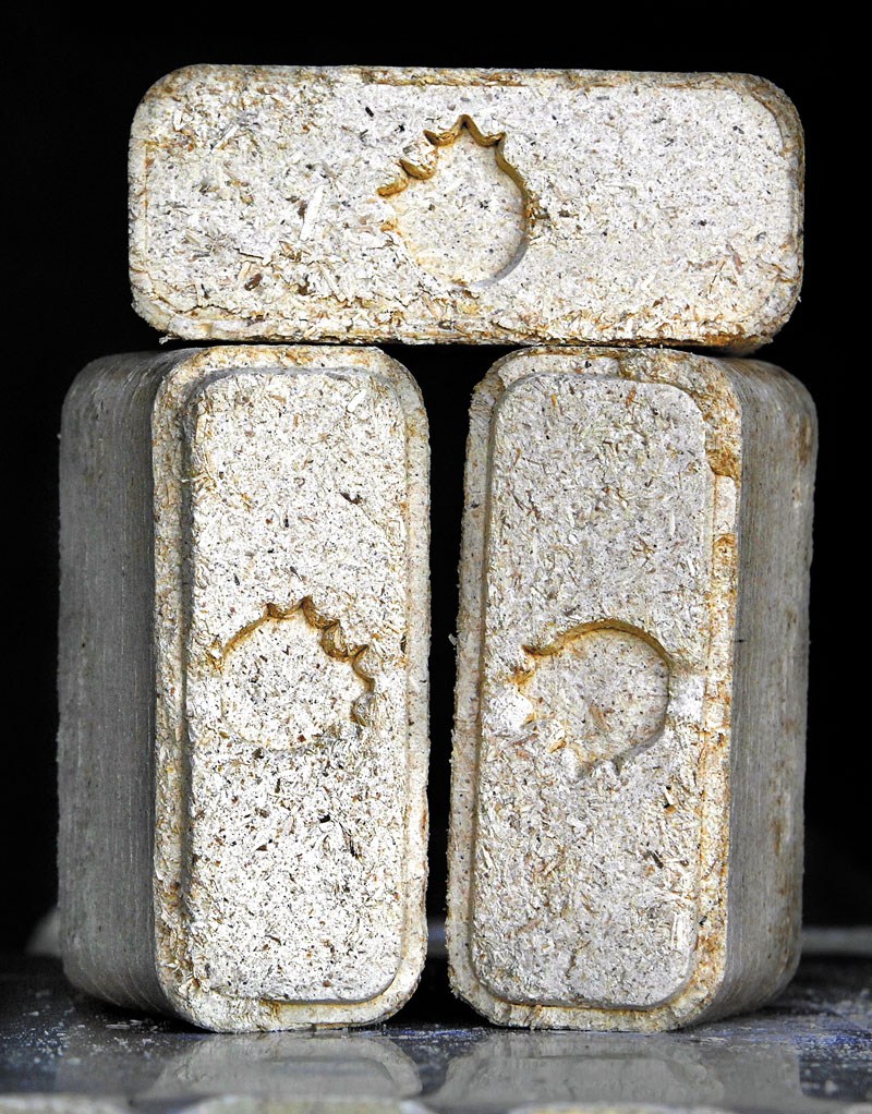Compressed wood fuel, or wood bricks, like the ones seen here at the Maine Biomass warehouse in Brunswick, are arriving on the alternative energy scene in Maine.
