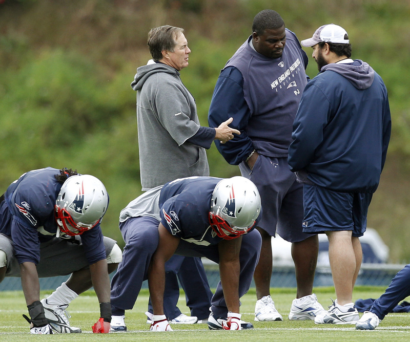 Coach Bill Belichick talks with a pair of assistant coaches as players work out while getting ready to face the Steelers on Sunday. New England is allowing an NFL-worst 322 passing yards and 423 total yards per game.