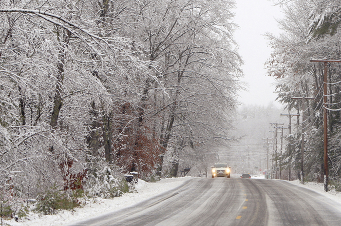 A car travels through the snow along Route 117 in Hollis today. Mixed precipitation is forecast for the rest of the day for much of Maine.