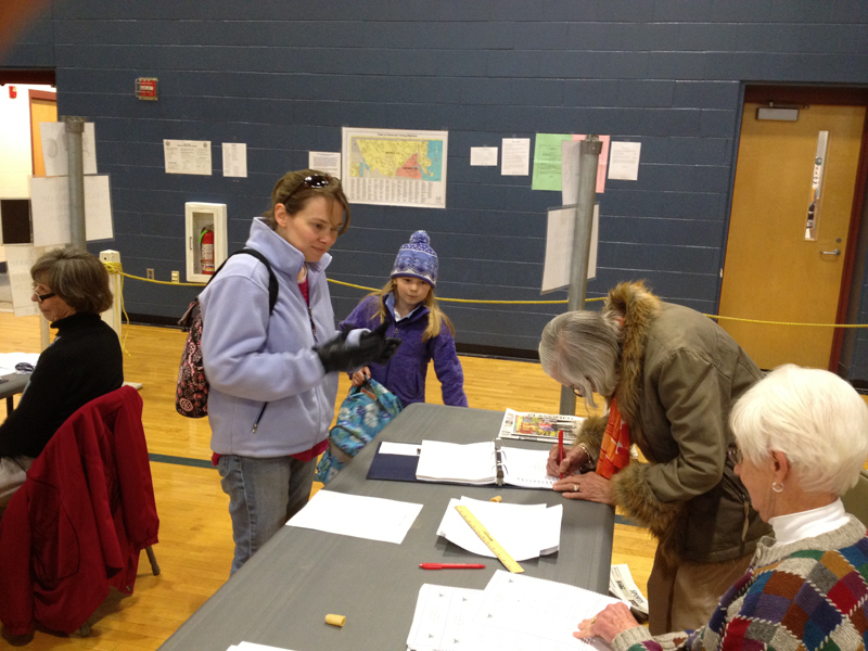 Linda Gee of Falmouth shares the voting experience with her daughter, Acadia Gee, 8, at Falmouth High School.