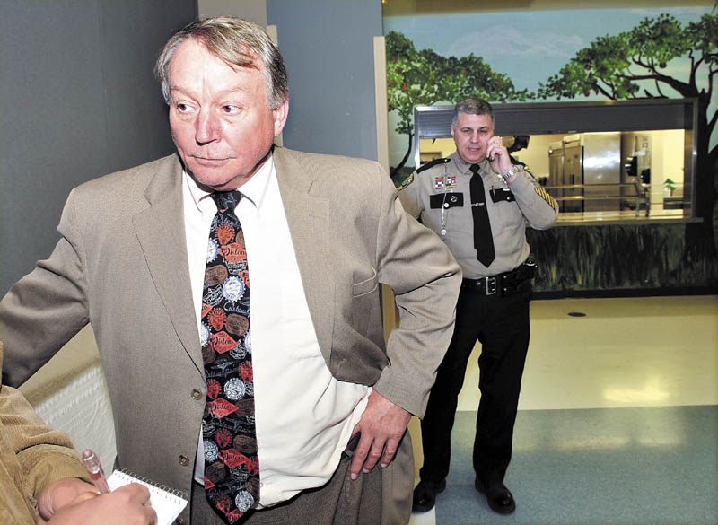 Eric Haley, superintendent of Waterville, Winslow and Vassalboro schools, speaks about a fire that caused damage in a bathroom at the Vassalboro Community School on Monday. At right is Kennebec Sheriff Deputy Scott Cyrway following a de-briefing with school staff and investigators with the state Fire Marshal's Office.