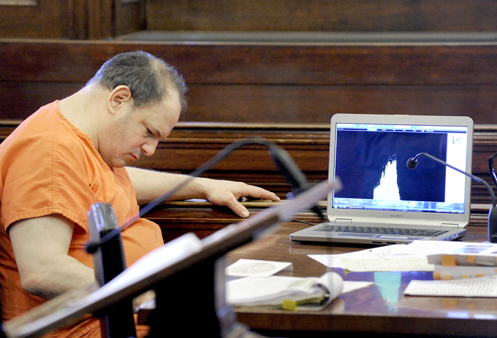 Steven Ricci listens to a recording of his victim's call to the Portland police, during his trial in Cumberland County Court today.