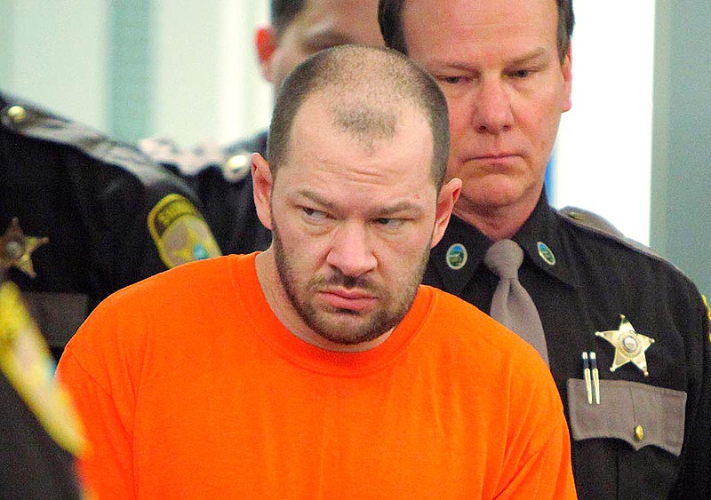 Gregory Rec/Staff Photographer: David Hobson is led into Ossipee District Court in Ossipee, N.H. on Wednesday for his arraignment on a felony escape charge. Hobson escaped from the Carroll County Jail in Ossipee, N.H. last Thursday.