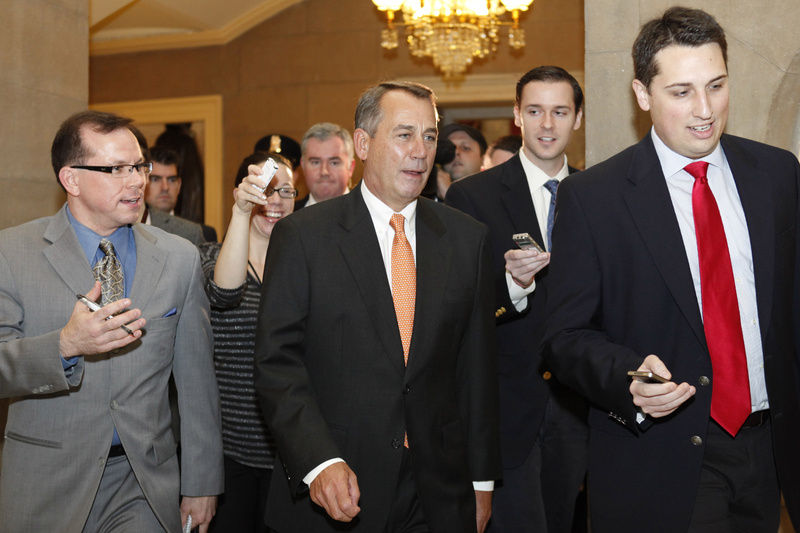 Reporters surround speaker of the House John Boehner of Ohio after a House vote on the payroll tax cut in Washington on Friday.