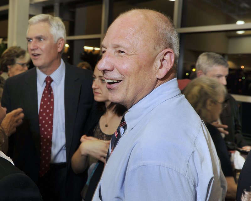 Mayor Michael Brennan visits with friends and supporters, including Steven Rowe, at left, during a reception at Portland's Ocean Gateway celebrating his inaugural Monday.