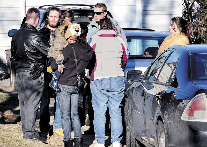 Maine State Police Detective Christopher Tupper, left, and Waterville Detective Lincoln Ryder, at right, talk to Justin DiPietro, the father of Ayla Reynolds, at his home on Violette Avenue in Waterville on Sunday.