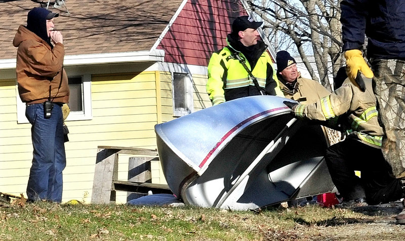 Searchers scour backyards and outbuildings at residences on Violette Avenue in Waterville for signs of the missing girl.