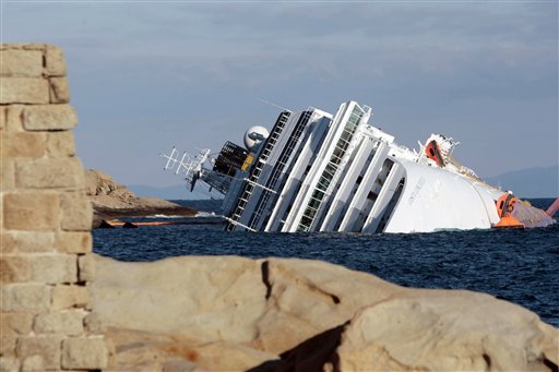 The cruise ship Costa Concordia leans on its side Tuesday after running aground on the tiny Tuscan island of Giglio, Italy, on Friday evening. (AP Photo/Gregorio Borgia)