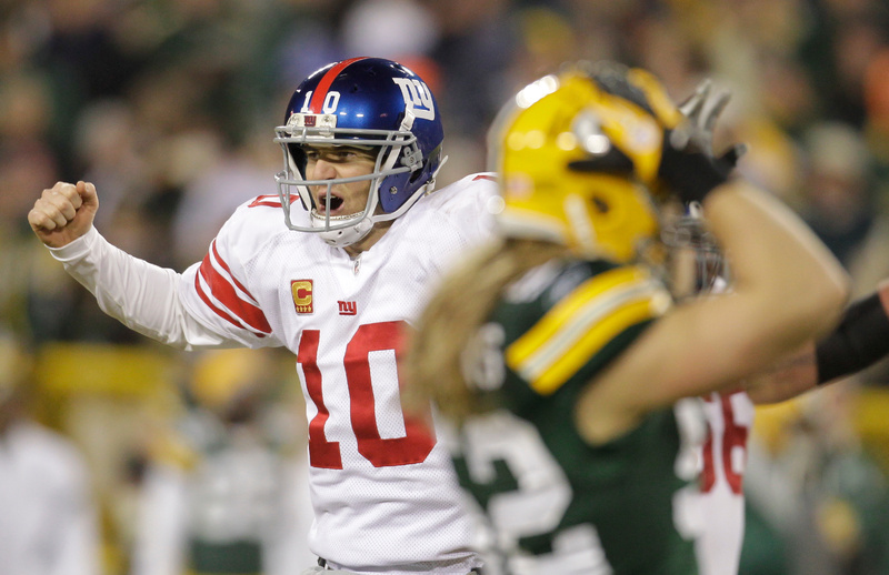 New York Giants quarterback Eli Manning reacts in front of Green Bay Packers linebacker Clay Matthews, right, after throwing a 37-yard touchdown pass to Hakeem Nicks in the first the first half of Sunday's playoff game in Green Bay, Wis. The Giants won, 37-20. They play San Francisco in the NFC championship game next Sunday night.