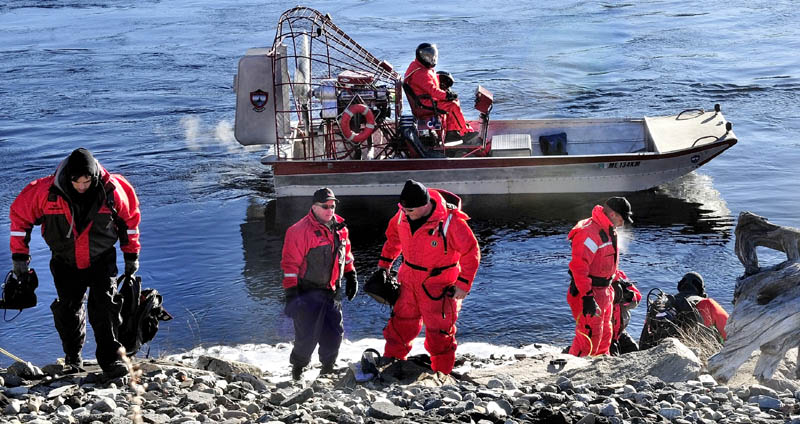 A Maine Warden Service boat comes ashore on the Kennebec River near the Hathaway Center in Waterville as three divers prepare to search below the dam for missing toddler Ayla Reynolds today.