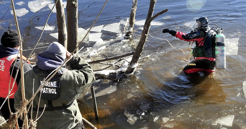 HARD SEARCH: Maine State Police diver Jarod Stedman encountered sunken wood and floating pieces of ice while searching underwater for signs of missing toddler Ayla Reynolds in the Kennebec River in Waterville on Wednesday.