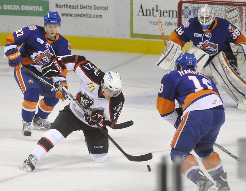 Andy Miele of the Pirates tries to control the puck in the Bridgeport zone during Portland’s 4-0 loss Saturday night at the Cumberland County Civic Center.