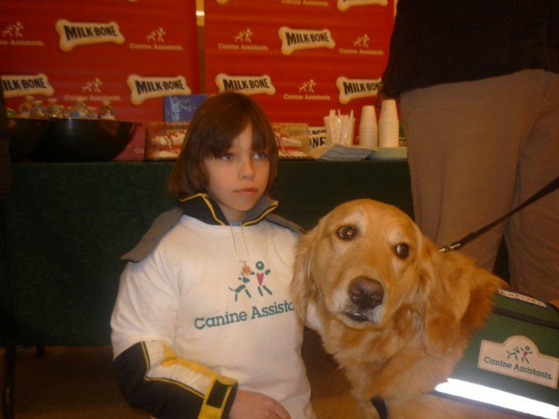 Seth Richards, who has epilepsy, spends time with a service dog similar to one he will be paired with once he is trained.