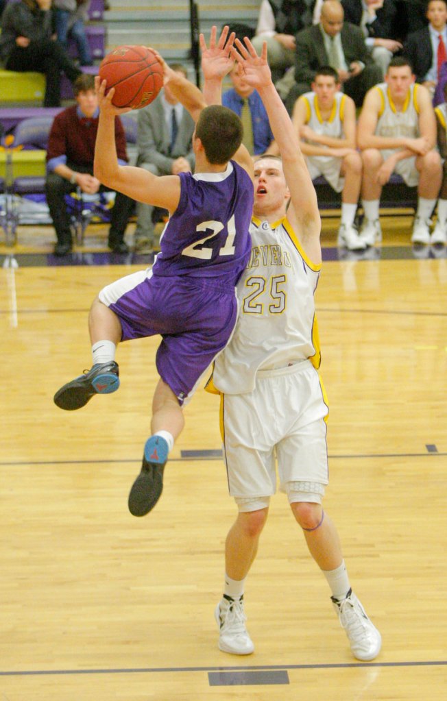 Jon Amabile of Deering goes up for shot against Shawn Grover. Amabile scored 17 points, but the Rams lost for the first time this season, 49-40.