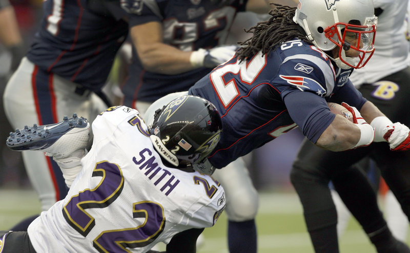 BenJarvus Green-Ellis of the Patriots scores a second-quarter touchdown as Baltimore’s Jimmy Smith hangs on during Sunday’s AFC championship game at Gillette Stadium. Green-Ellis ran for 68 yards on 15 carries.