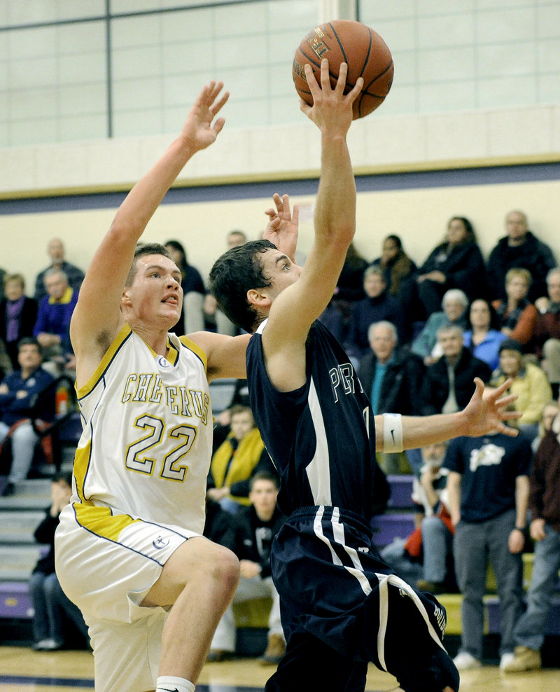Nick Volger of Portland drives to the basket against Cam Olson of Cheverus. Volger finished with seven points, including the winning layup with two seconds remaining.