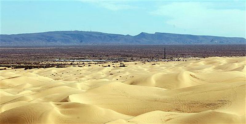 A mountain range along the border of California and Arizona rises in the distance Thursday, Feb. 23, 2012, near Glamis, Calif. Two Marine Corps helicopters collided Wednesday near this remote section of the California desert during a nighttime exercise, killing seven Marines in one of the deadliest military training accidents in years. (AP Photo/Lenny Ignelzi)