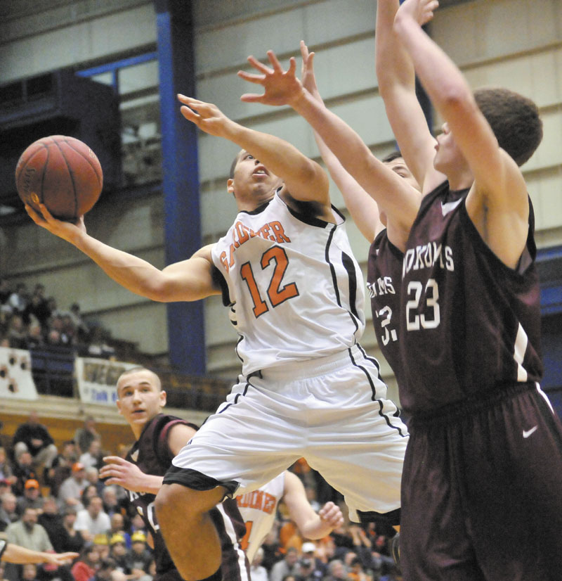 Gardiner’s Alonzo Connor, left, drives to the hoop against Nokomis defenders Chandler Foss, center, and Andrew Cartright in the first half of their Eastern Class B quarterfinal at the Bangor Auditorium. Gardiner won 56-47 in overtime.