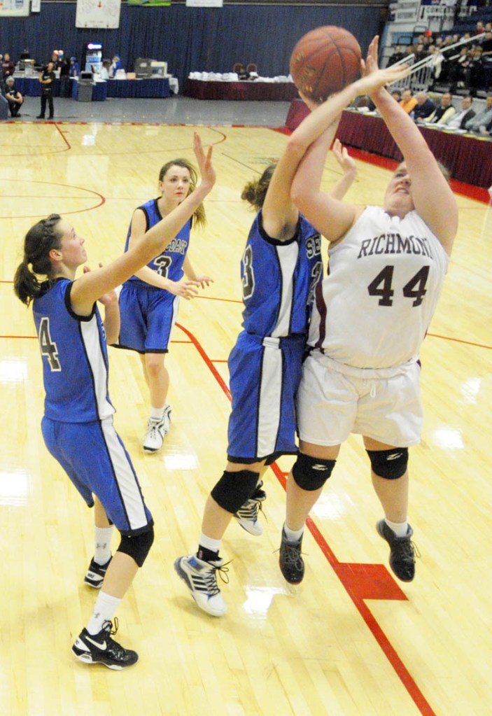 Ciarra Lancaster of Richmond is fouled by Ruth Towne of Seacoast Christian while taking a shot during the Western Class D semifinal at the Augusta Civic Center.