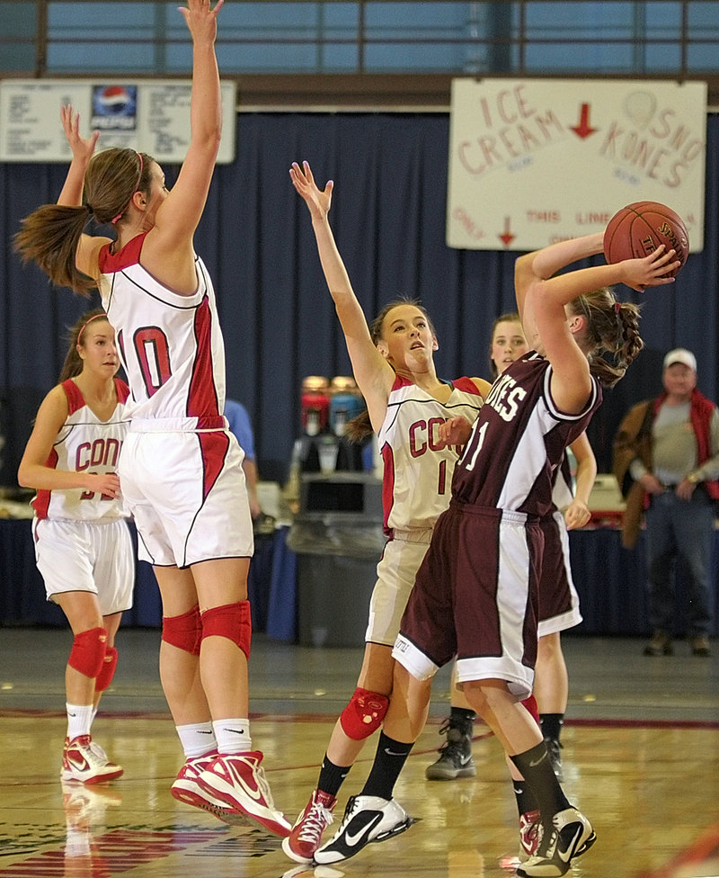 Tianna Harriman of Edward Little is pressured by Cony’s Julie Arbour, left, and Emily Quirion during the Eastern Class A final in Augusta. Cony won, 44-41.