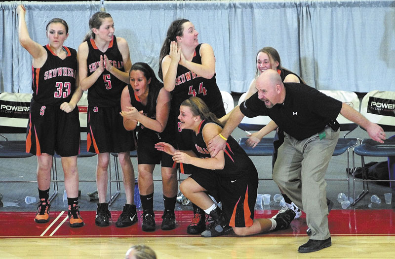 Players on the Skowhegan bench and Coach Heath Cowan celebrate as the Indians beat Mt. Blue in an Eastern Class A quarterfinal at the Augusta Civic Center.