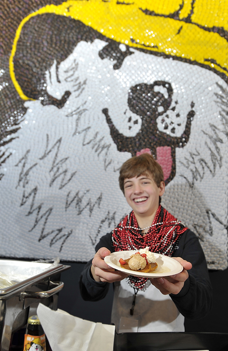 Reed Gordon, 15, son of Chris Gordon, owner of Sea Dog Brewing Company, serves a helping of Sea Dog Pumpkin-Ale Pancakes topped with cinnamon, brown sugar and butter, along with with Reed's Maple Syrup, at the Incredible Breakfast Cook-Off. The dish took second place and lost by only four votes.