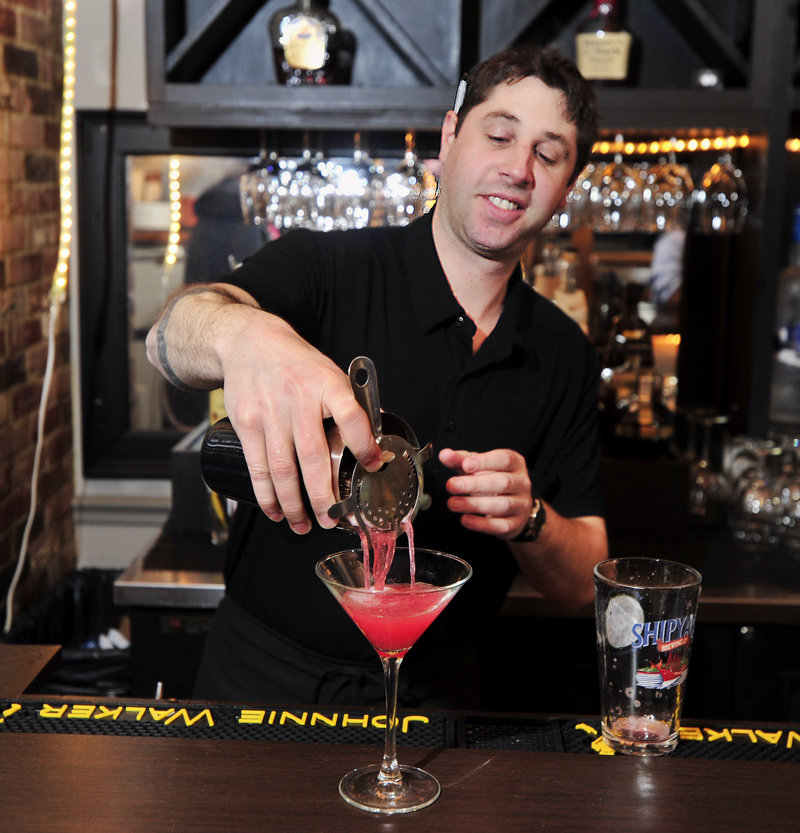 Bartender Tom Brita demonstrates the art of making a Cosmopolitan at 15 Exchange Grille in Portland.