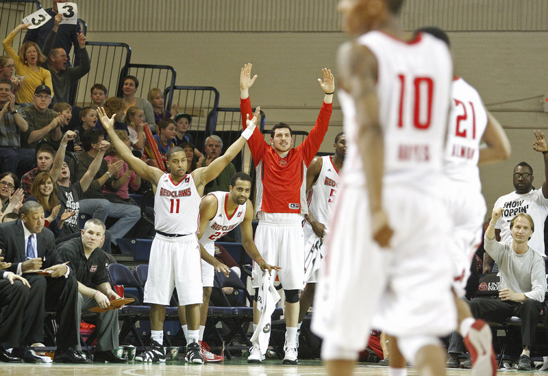 Players and fans react after Maine’s Kenny Hayes, 10, hit a 3-pointer in the fourth quarter Sunday at the Portland Expo.