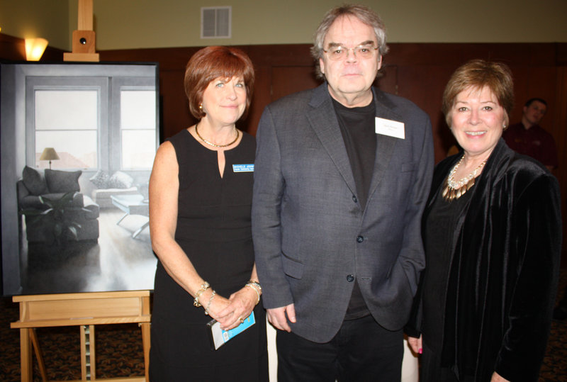 Cancer Community Center Executive Director Michele Johns, featured artist Nick Patten and board member and auction coordinator Corrine Bongiovanni, next to Patten’s painting titled “The Conservatory.”