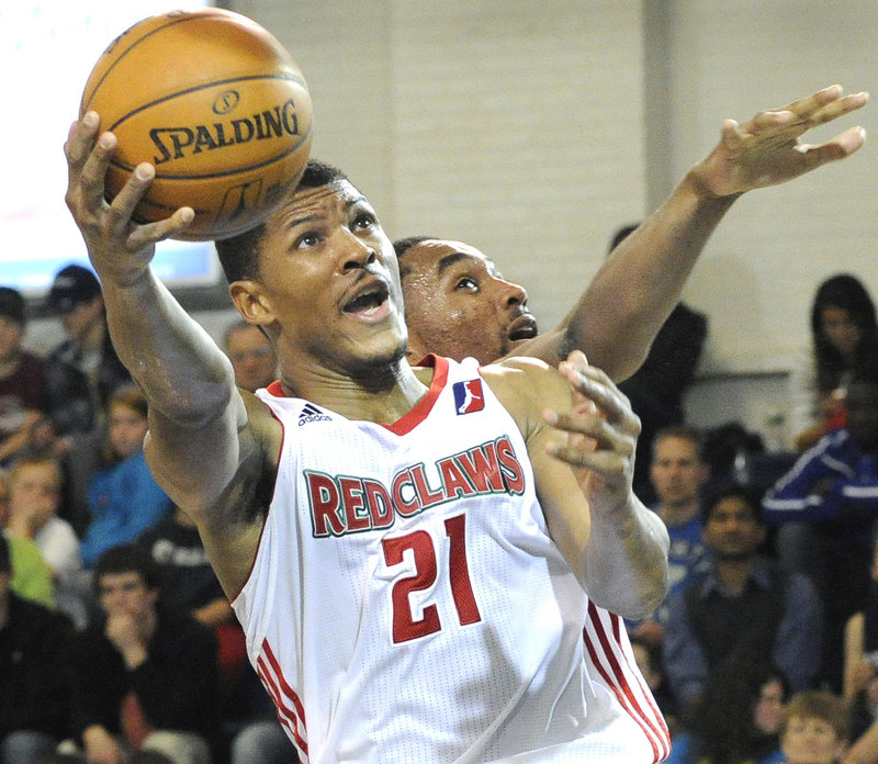 Morris Almond, who had 30 points and 10 rebounds, shoots around Da’Sean Butler of the Austin Toros during Austin’s 119-112 victory Friday night at the Portland Expo.