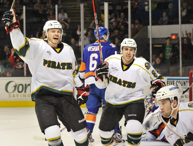 Alexandre Bolduc, left, and Ethan Werek celebrate a goal by teammate Brett MacLean in the first period Saturday night at the Cumberland County Civic Center. The Pirates rallied after giving up the game’s first two goals to beat Bridgeport 5-3 and move within two points of a playoff spot.