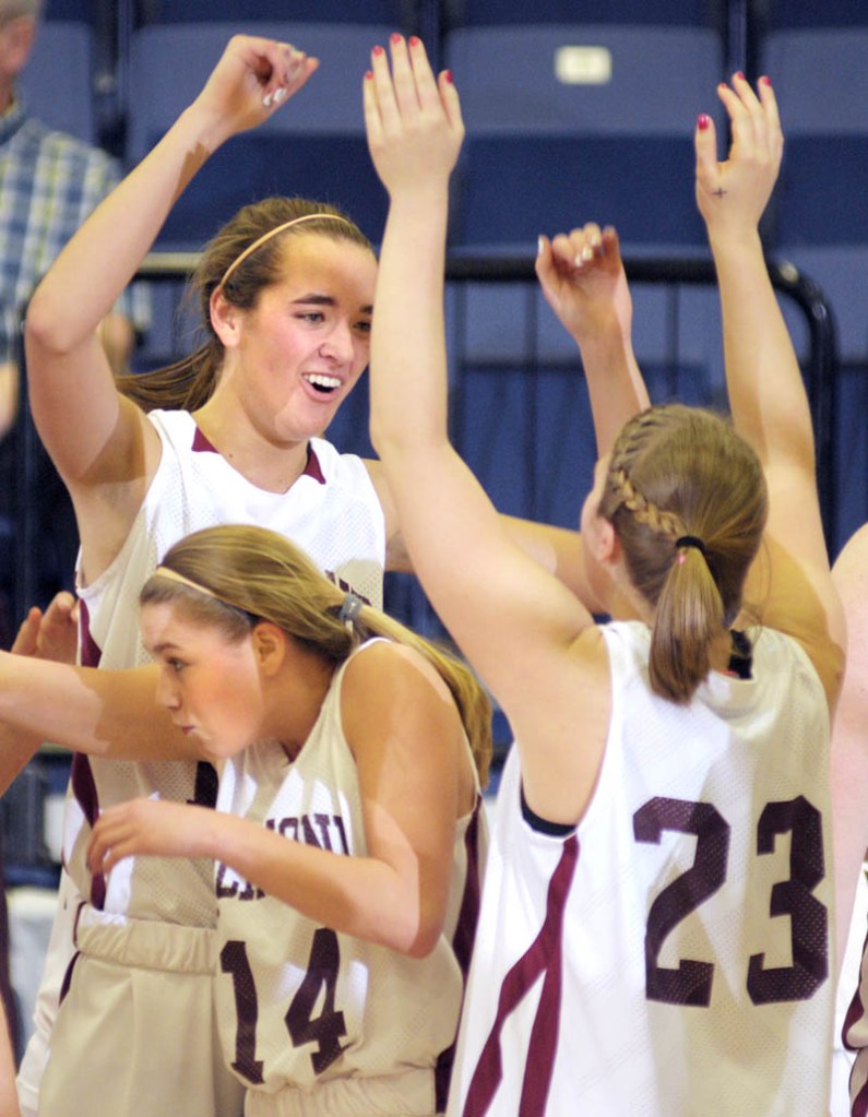 Richmond's Micheala Lewia, bottom, ducks under teammates Jamie Plummer, left, and Lindsy Hoopingarner after they beat Seacoast Christian in the Western Maine Class D semifinals. The Bobcats face Washburn for the Class D crown today.