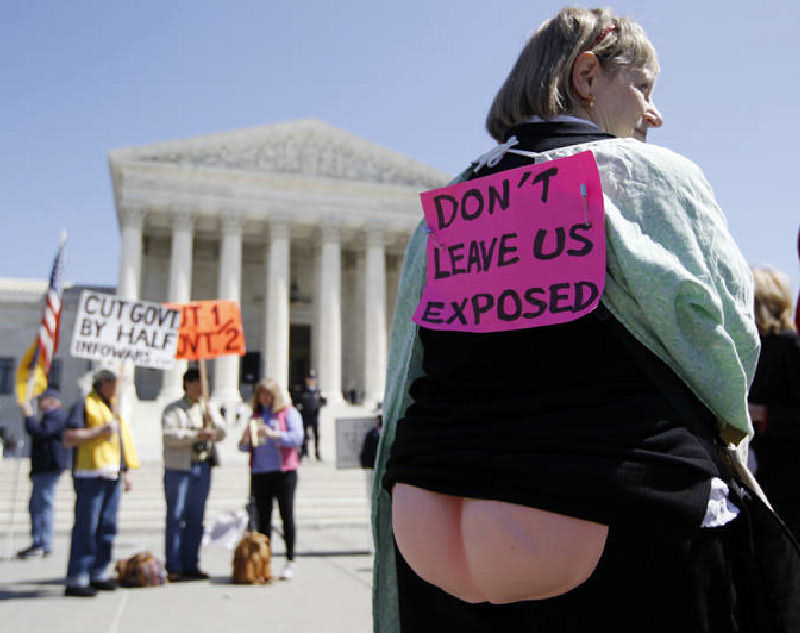 Joan Stallard, who supports health care reform, stands in front of the Supreme Court after Tuesday&rsquo;s session.