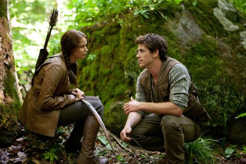 In this image released by Lionsgate, Jennifer Lawrence portrays Katniss Everdeen, left, and Liam Hemsworth portrays Gale Hawthorne in a scene from "The Hunger Games." (AP Photo/Lionsgate, Murray Close)