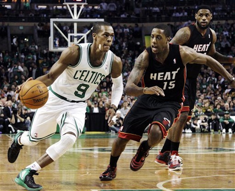 Boston Celtics guard Rajon Rondo (9) drives against Miami Heat guard Mario Chalmers (15) as forward LeBron James watches in the second half of an NBA basketball game in Boston, Sunday, April 1, 2012. The Celtics won 91-72. (AP Photo/Elise Amendola)