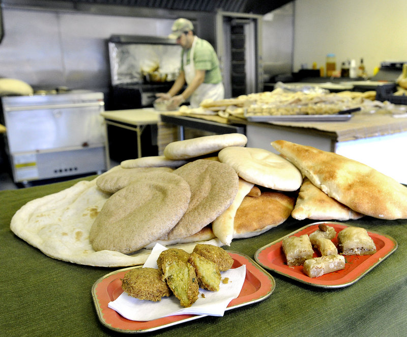 Among the products he prepares are, front, traditional favorites like falafel, left, baklava and bourma, and flatbreads such as tenur, pita and samoom.