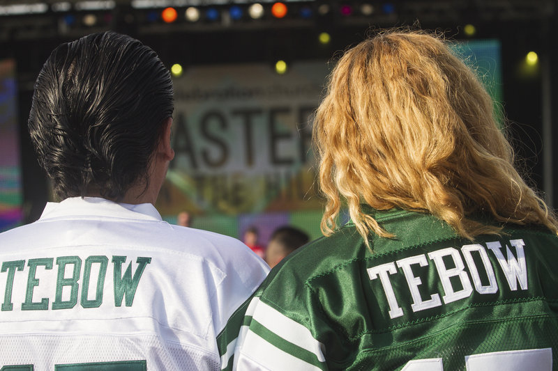 Jaime and Debbie Sandoval wait for New York Jets quarterback Tim Tebow to speak at Celebration Church’s Easter service in Georgetown, Texas.