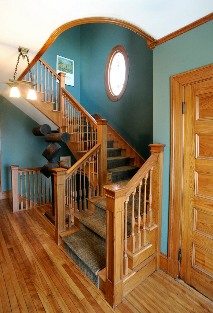 Original woodwork adorns the staircase in the hallway of the home. The interior needed work when they bought it, and Hawkes and Teas, both architects, chose to restore it to reveal its many charms.