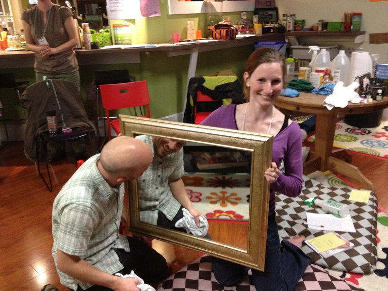 Joe Walsh, owner of Green Clean Maine, cleans a mirror at a meeting of the Holistic Moms Network in April. Erin Moulton of Windham assists with the demonstration. Walsh uses only environmentally friendly cleaners in his business.