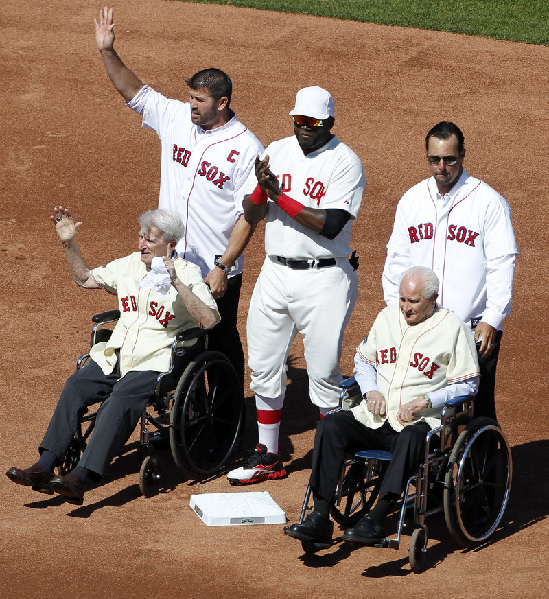 Johnny Pesky, left, and Bobby Doerr were wheeled to second base by the recently retired Jason Varitek and Tim Wakefield, and escorted by David Ortiz during the Fenway Park celebration.