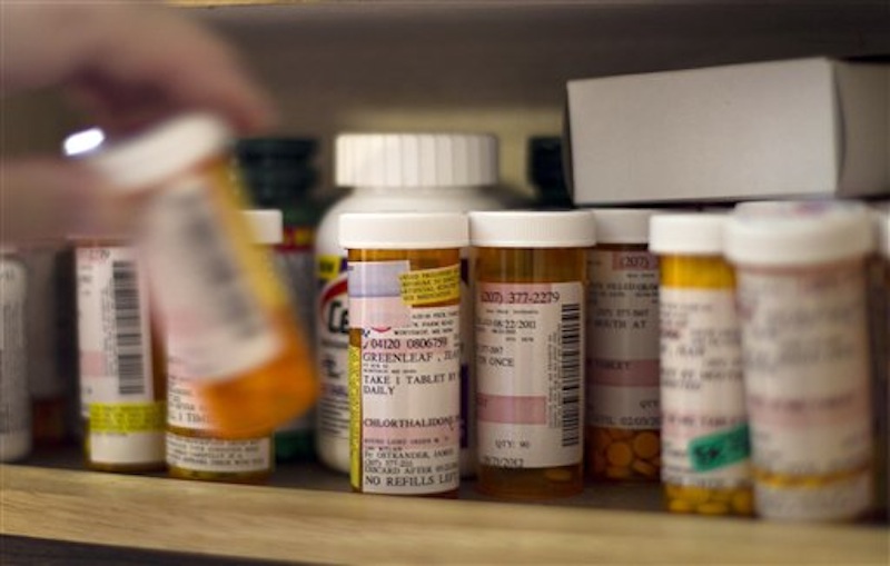 In this photo made Friday, May 11, 2012, Jean Greenleaf returns her medication to a cabinet at her home in Winthrop, Maine. Greenleaf, 73, originally stood to lose funding for the drugs she takes for diabetes, cholesterol, a stomach disorder and depression under Gov. LePage's original budget proposal, but a compromise was reached by the Appropriations Committee. (AP Photo/Robert F. Bukaty)