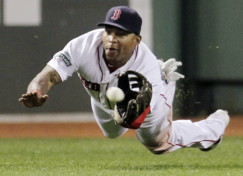 Boston Red Sox center fielder Marlon Byrd dives to catch a fly ball by Detroit Tigers' Gerald Laird in the eighth inning at Fenway Park Wednesday night.