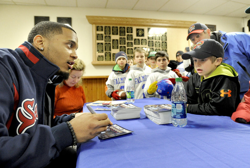 Patriots safety Patrick Chung chats with Connor DeCoster, 6, and his dad, Jay DeCoster, from Turner during his visit to Hadlock Field Tuesday night.