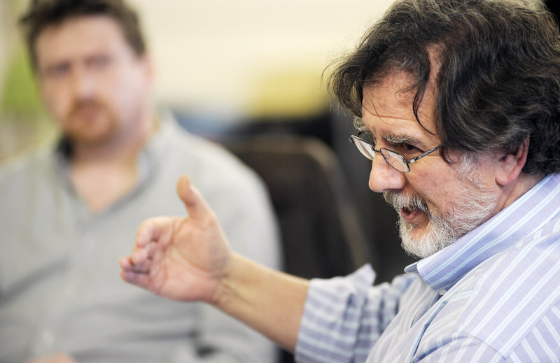 Director Andrew Harris talks with playwrights and actors during rehearsal.