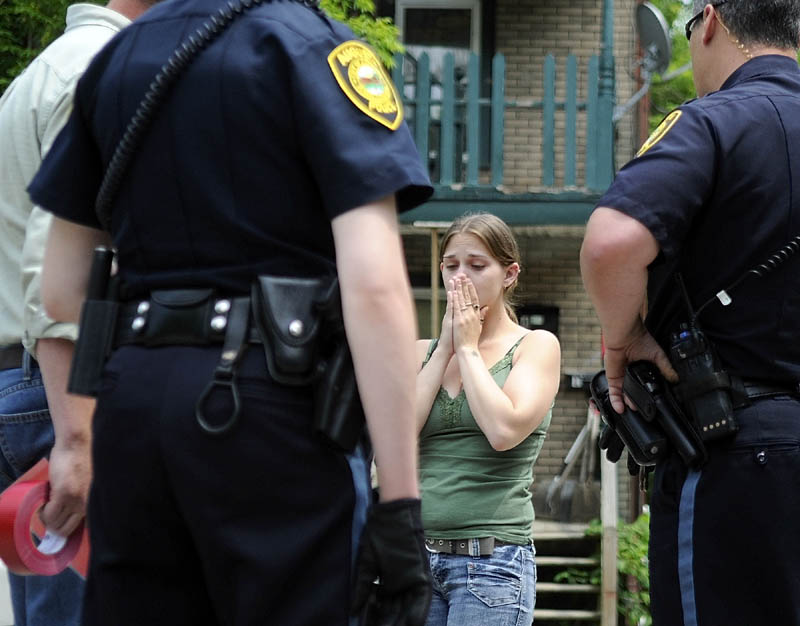 UNSAFE CONDITIONS: Andrea Jellison reacts to being told that her apartment at 11 State Street in Augusta had been condemned as unsafe. Jellison, her husband and child were told by city officials that the wooden stairs and deck entrance to the building is unsafe and were ordered to relocate.