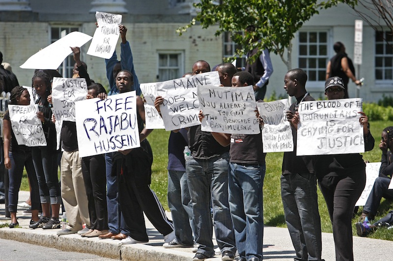 Immigrants from Burundi demonstrate on Spring Street, across from the Holiday Inn by the Bay, on Saturday to protest the involvement of Edouard Nduwimana, Burundi’s interior minister, in a youth conference in Portland organized by the head of the International Christian Fellowship Church on Munjoy Hill.